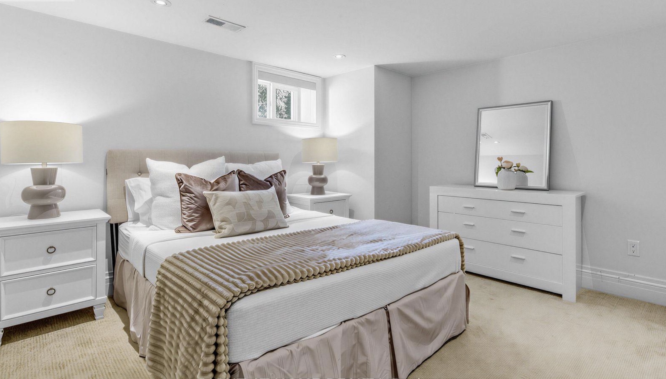 Light bedroom with a bed and dresser