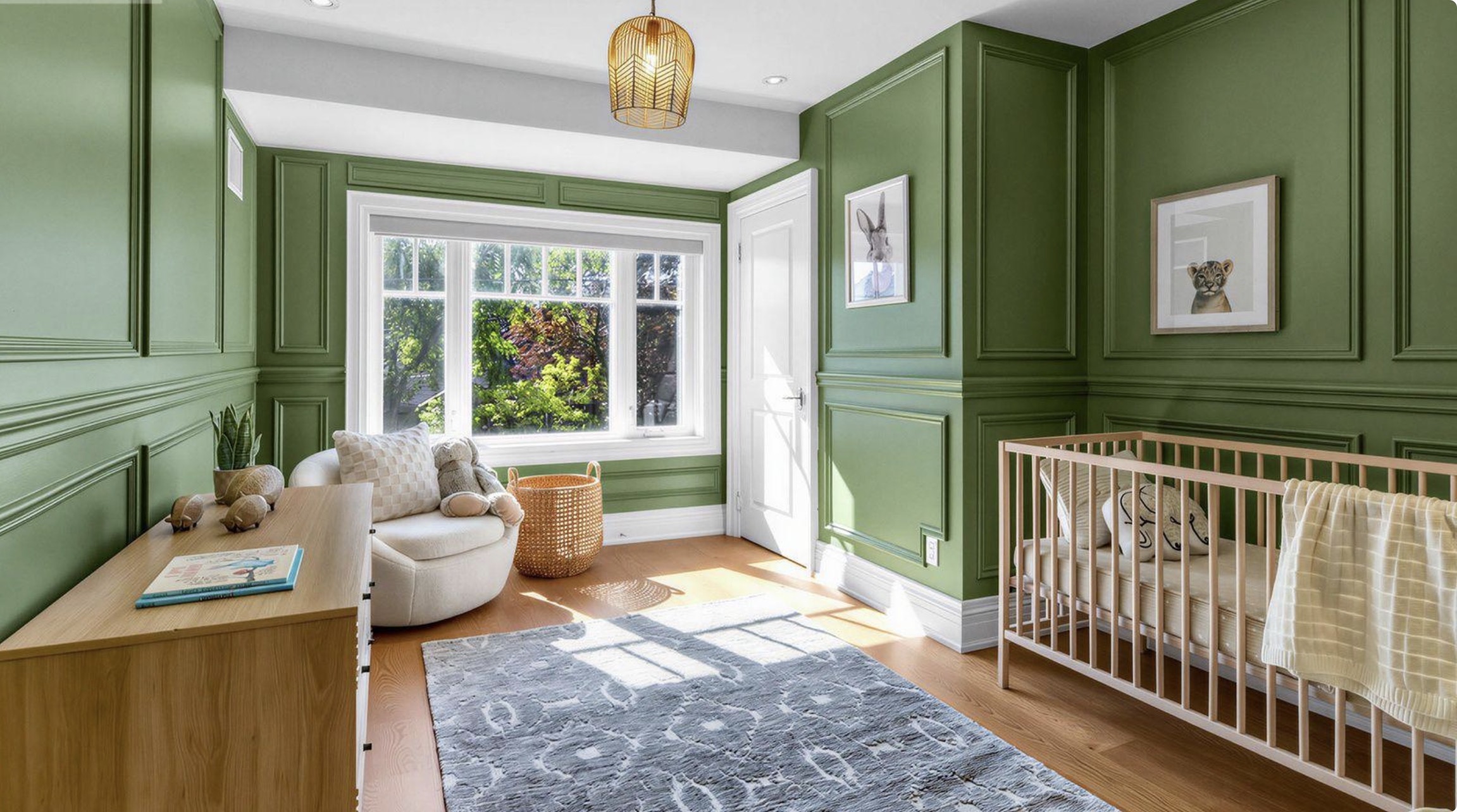 Green nursery with decorative wall moulding